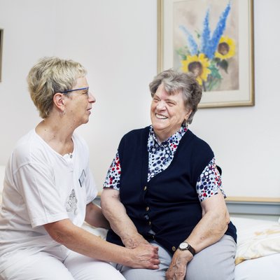 Pflegekraft zugewandt zu Bewohnerin